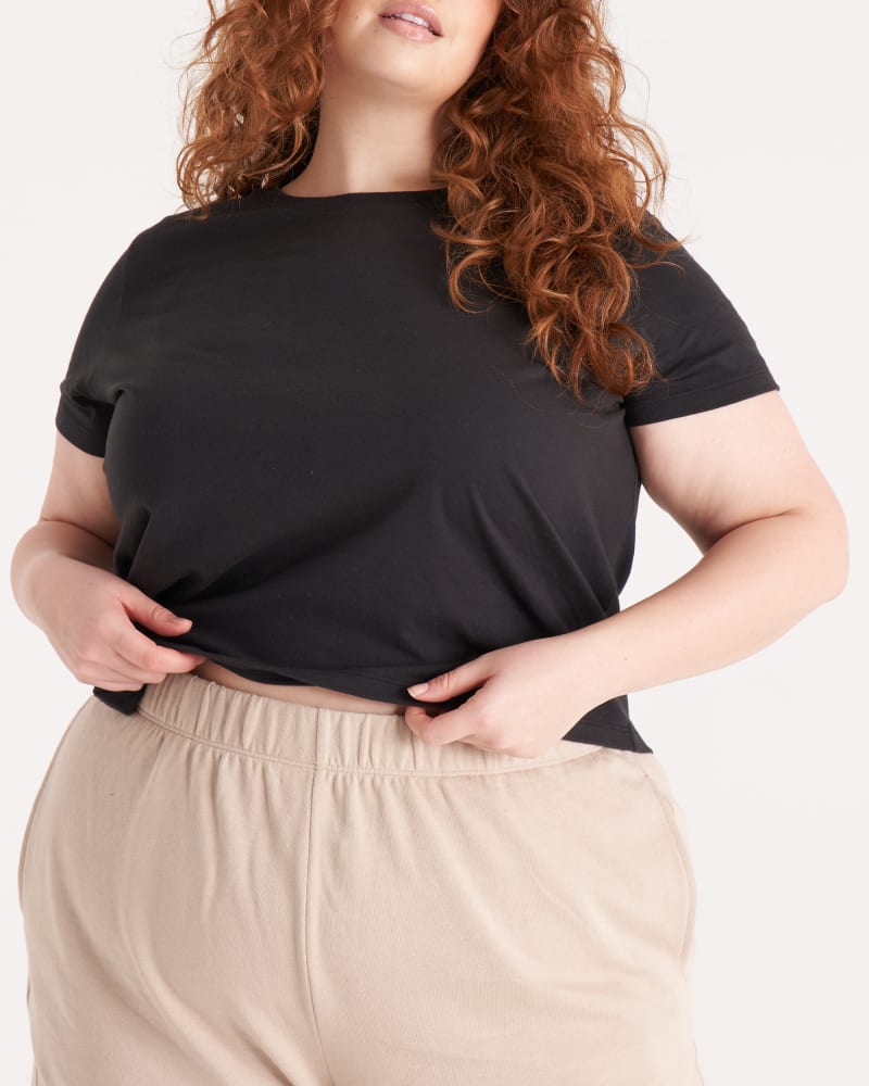 Front of a model wearing a size 3X The Crop Tee in Onyx by The Standard Stitch. | dia_product_style_image_id:288191